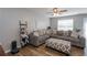Comfortable living room with a large sectional sofa, wood floors, and ceiling fan at 183 Venture Path, Hiram, GA 30141