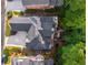 Overhead shot of a house with a gray roof, spacious driveway, manicured landscaping, and a backyard deck at 4569 Fountain Ne Dr, Marietta, GA 30067