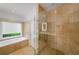 A bright bathroom featuring a glass door shower and a soaking tub at 4569 Fountain Ne Dr, Marietta, GA 30067