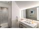 Bright bathroom featuring a large, modern sink with a big well-lit mirror and glass-enclosed shower at 4569 Fountain Ne Dr, Marietta, GA 30067