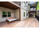 Outdoor deck features a daybed with orange pillows, providing a relaxing spot next to large windows and lush greenery at 4569 Fountain Ne Dr, Marietta, GA 30067
