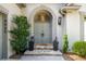 Elegant entryway featuring a stone steps, arched door, decorative plants, and striking house numbers at 4569 Fountain Ne Dr, Marietta, GA 30067