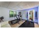 Brightly lit home gym with fitness equipment, a treadmill and blue accent lighting at 4569 Fountain Ne Dr, Marietta, GA 30067