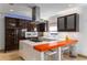 Stylish kitchen with stainless steel appliances, rich wood cabinetry, and a bright orange island at 4569 Fountain Ne Dr, Marietta, GA 30067