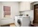 Functional laundry room with modern washer/dryer, storage cabinets, and natural light at 4569 Fountain Ne Dr, Marietta, GA 30067
