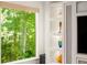 Brightly lit built-in shelves next to a large window with green trees visible outside at 4569 Fountain Ne Dr, Marietta, GA 30067