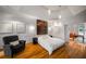 Spacious main bedroom with hardwood floors, unique artwork, and a cozy sitting area at 4569 Fountain Ne Dr, Marietta, GA 30067