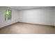 A simple room with tiled floor and base trim, and a window overlooking a natural green space at 4569 Fountain Ne Dr, Marietta, GA 30067