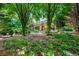 Scenic backyard featuring a hammock, lush greenery, ferns, and mature trees at 1181 Fairview Ne Rd, Atlanta, GA 30306