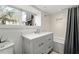 Bright bathroom features a white vanity, subway tile shower, and a large window with a leafy outdoor view at 1181 Fairview Ne Rd, Atlanta, GA 30306