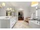 A bright primary bathroom with marble floors, dual sinks, and a walk-in closet for plenty of storage at 1181 Fairview Ne Rd, Atlanta, GA 30306