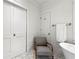 Well-lit bathroom features marble floors, a freestanding tub, and a comfortable chair at 1181 Fairview Ne Rd, Atlanta, GA 30306