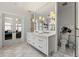 Bright bathroom with dual sink vanity, marble floors, and view to stylishly decorated bedroom at 1181 Fairview Ne Rd, Atlanta, GA 30306