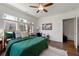 Light-filled bedroom with a comfortable bed, ceiling fan, hardwood floors, and decoratively styled at 1181 Fairview Ne Rd, Atlanta, GA 30306