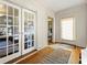 Foyer with hardwood floors, white trim, paneled glass doors, and natural light at 1181 Fairview Ne Rd, Atlanta, GA 30306