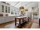Spacious eat-in kitchen features gray cabinetry, stainless appliances, island with seating, and modern pendant lighting at 1181 Fairview Ne Rd, Atlanta, GA 30306