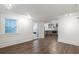 Bright living room with hardwood floors leading to modern kitchen and an entryway door at 1181 Fairview Ne Rd, Atlanta, GA 30306