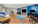 Cozy basement recreation room featuring a TV, study space, blue accent wall, and laminate wood flooring at 1181 Fairview Ne Rd, Atlanta, GA 30306