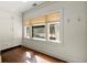 Bright room features built-in cabinets, three large windows with wooden blinds, and gleaming hardwood floors at 1181 Fairview Ne Rd, Atlanta, GA 30306