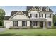 Charming two-story home with board and batten siding, a well-manicured lawn, and inviting front porch at 1285 Pj East Rd, Covington, GA 30014