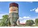 A vintage farm silo with 'Southern Belle Farm' logo stands tall against a scenic backdrop of fields and trees at 1285 Pj East Rd, Covington, GA 30014