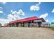 Exterior of a farm stand with a gravel parking lot and signs advertising fresh fruits and local produce at 1285 Pj East Rd, Covington, GA 30014