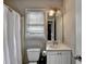 Bathroom featuring a white vanity, a toilet, and a shower/tub combination at 200 Mona Ct, Lawrenceville, GA 30044
