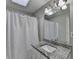 Neutral bathroom with granite countertop and a shower with white curtain at 200 Mona Ct, Lawrenceville, GA 30044
