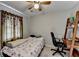 Cozy bedroom with a ceiling fan and a wooden bookshelf with a built-in desk at 200 Mona Ct, Lawrenceville, GA 30044