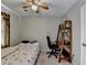 Cozy bedroom with a ceiling fan and a wooden bookshelf with a built-in desk at 200 Mona Ct, Lawrenceville, GA 30044