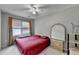 Cozy bedroom with bright window, ceiling fan, and a classic dresser with a mirror at 200 Mona Ct, Lawrenceville, GA 30044