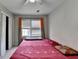 Bedroom featuring a bright window with blinds, warm decor, and ample closet space at 200 Mona Ct, Lawrenceville, GA 30044