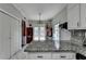 Modern kitchen with stainless steel appliances, granite counters, island and ample storage space, perfect for cooking and gathering at 200 Mona Ct, Lawrenceville, GA 30044