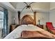 Bright and airy main bedroom features a four-poster bed with marble nightstands and a ceiling fan at 200 Mona Ct, Lawrenceville, GA 30044