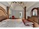 Spacious main bedroom features a four-poster bed, ceiling fan, and ensuite bathroom access at 200 Mona Ct, Lawrenceville, GA 30044