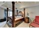 Spacious main bedroom featuring a tray ceiling, a four poster bed, and decorative lighting at 200 Mona Ct, Lawrenceville, GA 30044