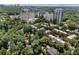 Aerial view showing homes with mature trees, a pool, and high-rise apartments at 2525 Peachtree Rd # 28, Atlanta, GA 30305