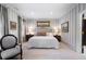 Elegant bedroom featuring gray and white striped wallpaper and neutral color accents and decor at 2525 Peachtree Rd # 28, Atlanta, GA 30305