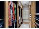 Custom closet with wood frame is filled with colorful clothes and features multiple shelves at 2525 Peachtree Rd # 28, Atlanta, GA 30305