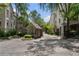 Gated community entrance with guard house, stone walls, and mature landscaping at 2525 Peachtree Rd # 28, Atlanta, GA 30305