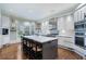 Modern kitchen with white cabinets, stainless steel appliances, and a spacious center island at 2525 Peachtree Rd # 28, Atlanta, GA 30305
