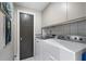 Functional laundry room with tile floors, washer, dryer, and cabinetry at 2525 Peachtree Rd # 28, Atlanta, GA 30305