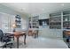 Office space featuring a dark wood desk with built-in shelves and two windows with plantation shutters at 2525 Peachtree Rd # 28, Atlanta, GA 30305