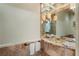 Stylish powder room with marble countertop, designer mirror, and elegant lighting at 2525 Peachtree Rd # 28, Atlanta, GA 30305