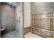Marble shower with a built-in bench and multi-setting wall mounted showerhead, adjacent to towel warmer at 2525 Peachtree Rd # 28, Atlanta, GA 30305