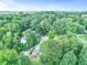 An aerial view of a home nestled within a lush green environment with mature trees and a private lot at 2896 Tiffany Cir, Lawrenceville, GA 30044