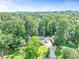 Aerial view of a house surrounded by a forest of lush trees at 2896 Tiffany Cir, Lawrenceville, GA 30044