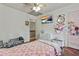 Cozy bedroom featuring wood floors, a ceiling fan, and a TV at 2896 Tiffany Cir, Lawrenceville, GA 30044