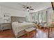 Comfortable bedroom features a padded headboard and refinished hardwood floors at 2896 Tiffany Cir, Lawrenceville, GA 30044