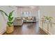 Open living room featuring hardwood floors, a comfortable gray sofa, and stylish gold accents at 2896 Tiffany Cir, Lawrenceville, GA 30044